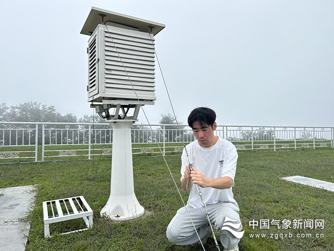 7月28日上午,嵩山气象站工作人员加固百叶箱,以应对台风"杜苏芮"风雨