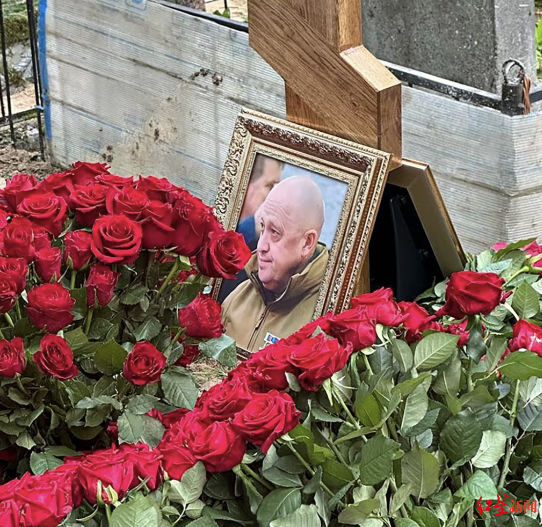 ▲根据社交平台流传的现场图片显示，墓碑中间摆放着普里戈任生前的照片，周围铺满了红色的玫瑰