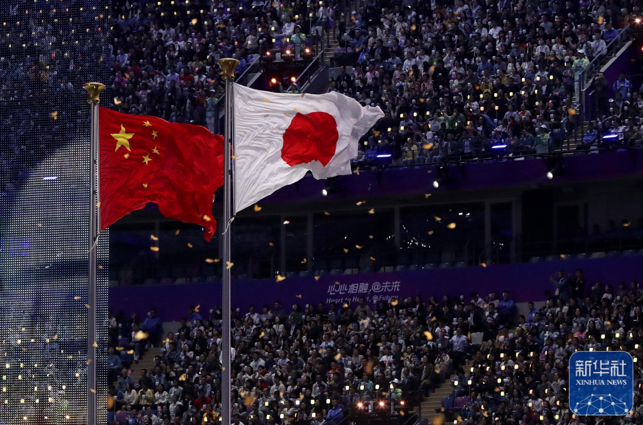 中华人民共和国国旗和日本国旗在闭幕式现场飘扬.