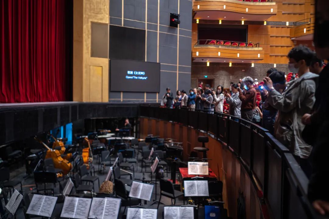 幕间,观众们好奇地围拢在乐池周围,拍照打卡.