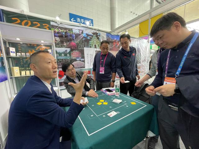 智博会上,薛文(左一)带来了公司研发的掼牌,报牌卡等.