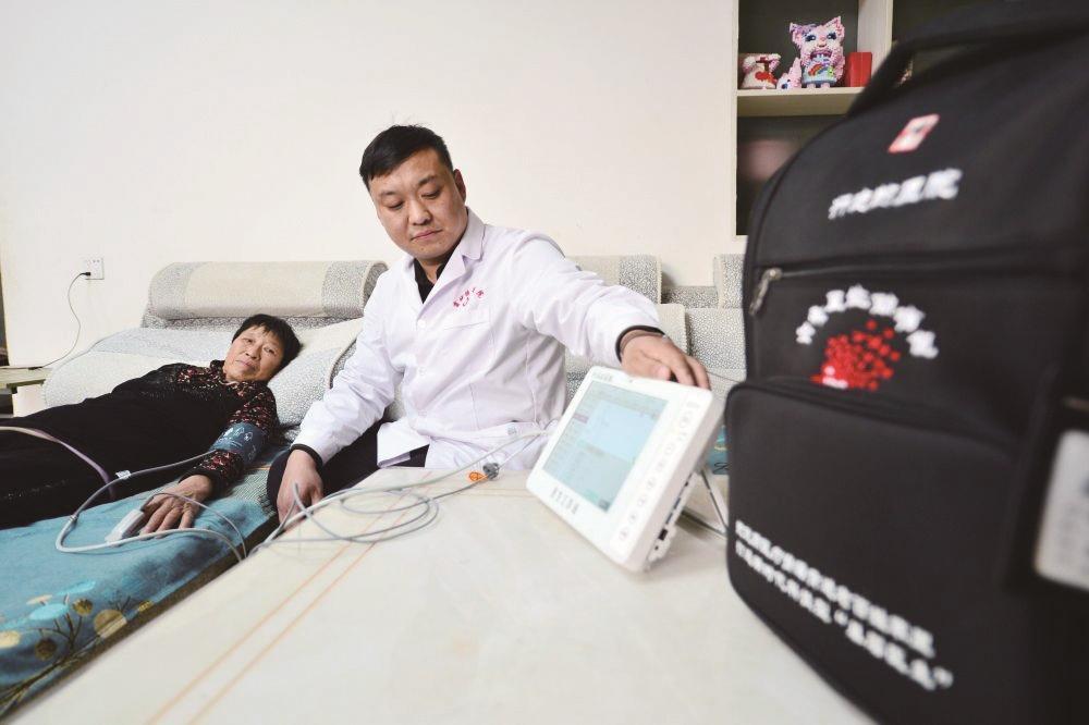 12月4日,在成安县北连送村,村医使用全科医生助诊包内的设备为一名