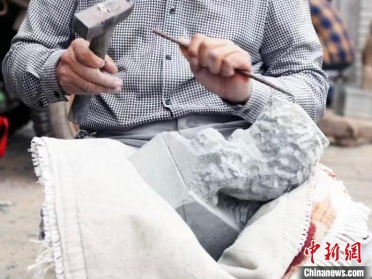 图为绥德石匠在雕刻石狮子. 受访者供图