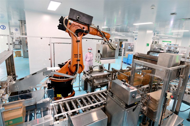 2023年12月12日，在石家庄市栾城区神威药业集团的注射剂生产车间，机器人在进行小盒装箱工作。新华社记者王晓摄