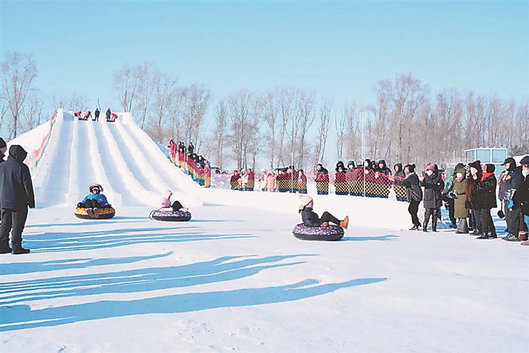 游客在查哈阳农场百米俯冲雪道尽情玩耍。 祁岩摄