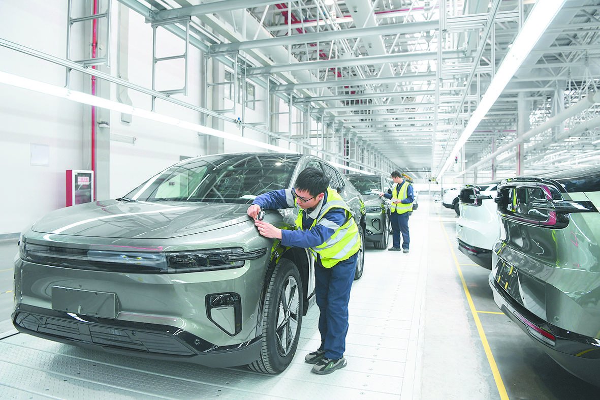 2024年3月14日,工作人员在长安汽车重庆渝北新工厂总装车间进行整车