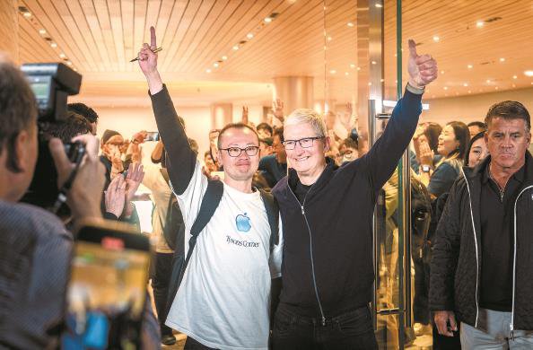 昨晚7时，苹果CEO库克现身静安店开业仪式，并与首批顾客合影留念 本报记者 陈梦泽 摄