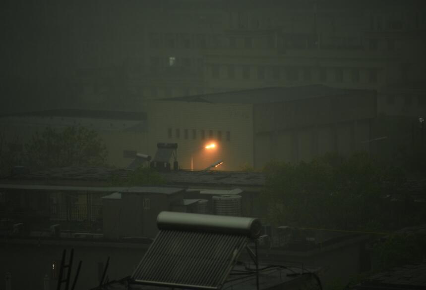△图源潇湘晨报记者吴琳红 暴雨袭城，正在“加班”的路灯。