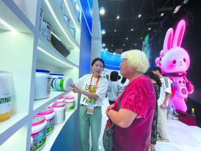     第四届中国国际消费品博览会展馆内，一名工作人员向老人介绍展品。“银发经济”中的女性消费同样不可忽视。刘旭/摄