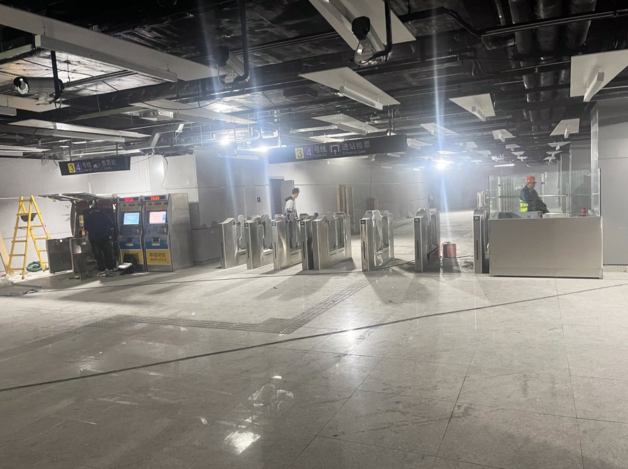 △4月25日，直连通道里，地铁工作人员正在对闸机设备进行调试，为27日上午正式开通做最后的准备。
