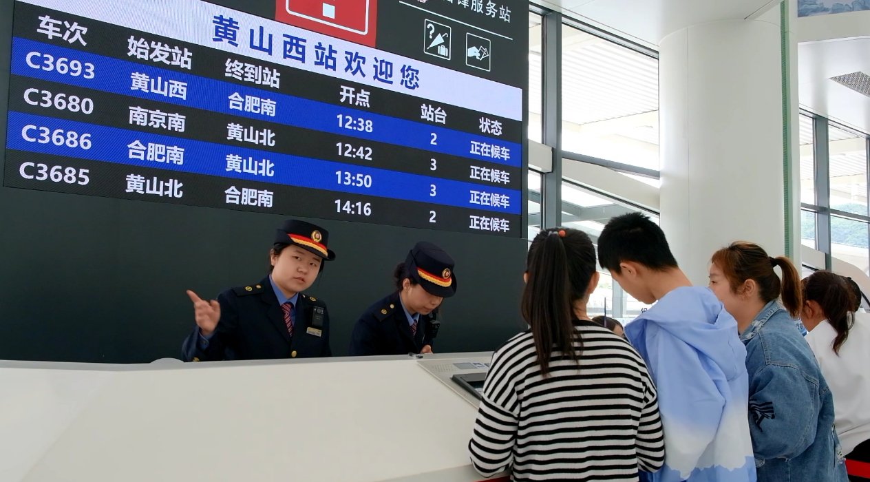 黄山西站12306服务台工作人员解答旅客咨询。    汪林  摄
