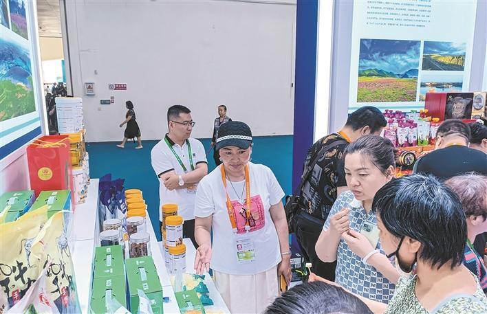 4月18日，在第四届中国国际消费品博览会上，消费者在兵团展区品尝驼乳馕。沙米哈·沃纳尔汗 摄