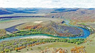 更远处是缓缓流动的卧牛河与白云