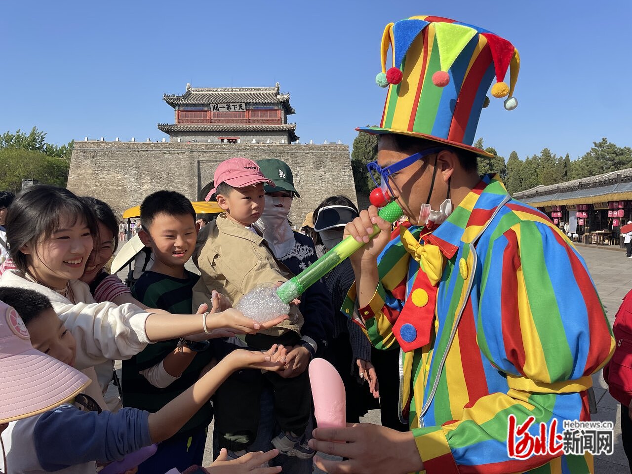5月4日，山海关区一关景区内小丑表演吸引孩子们与之积极互动。河北日报记者 孙也达摄