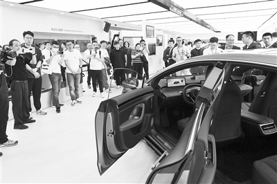 在2024北京车展上，参观者观看一款新能源汽车的智能车控系统演示。 新华社记者 鞠焕宗摄