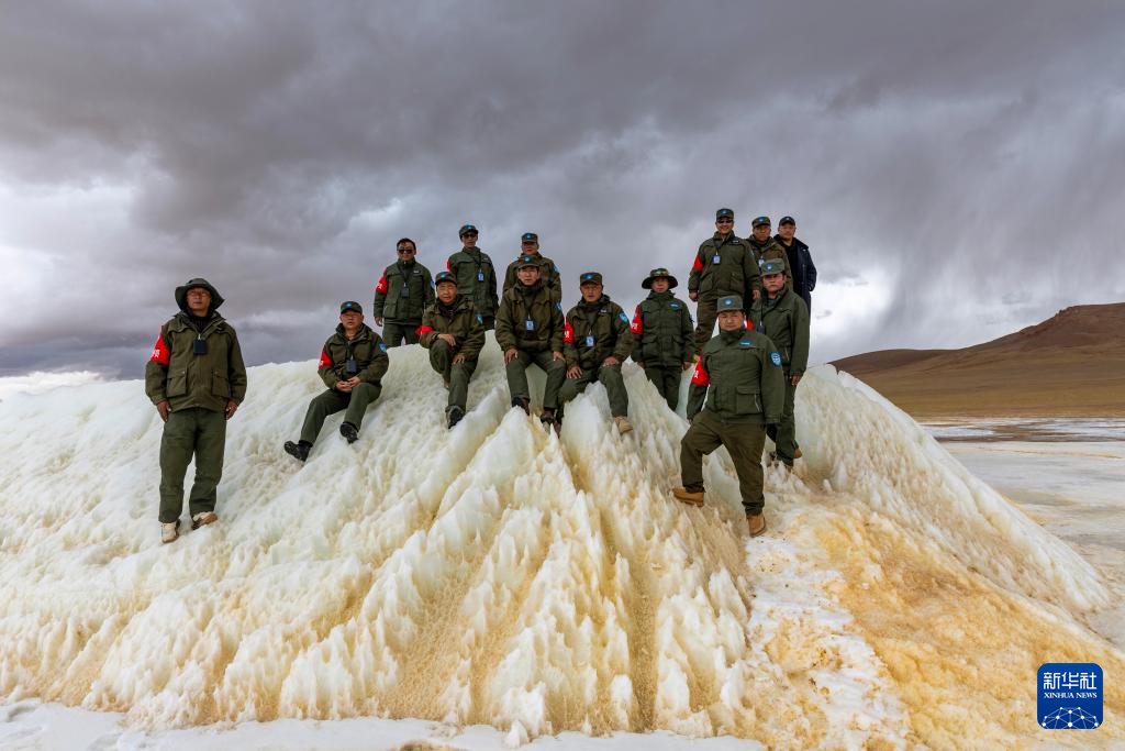 野生动物专业管护队员在巡护路上一处垭口的冰雪堆上合影（5月7日摄）。新华社记者 姜帆 摄