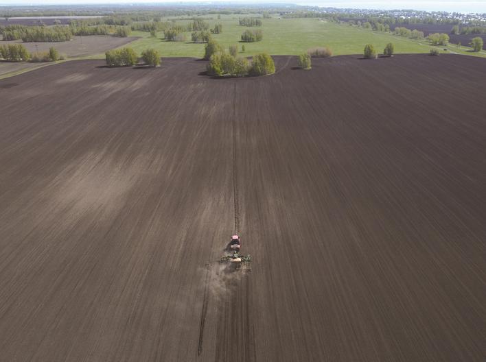 5月17日，在俄罗斯新西伯利亚州列宁斯科耶村附近，农民在田地内播种小麦（无人机照片）。 新华社/路透