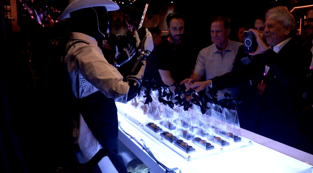 在現(xiàn)場充當「吧臺服務生」的 Optimus | 圖片來源：Tesla?視頻截圖