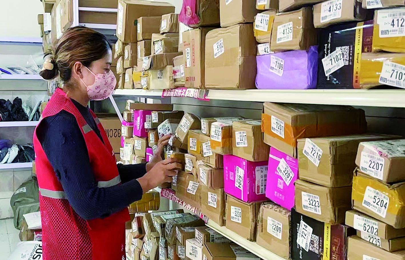 快递配送员在莎车县的代收点里整理快递