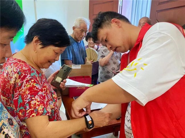 老人们体验智能手环监测建康