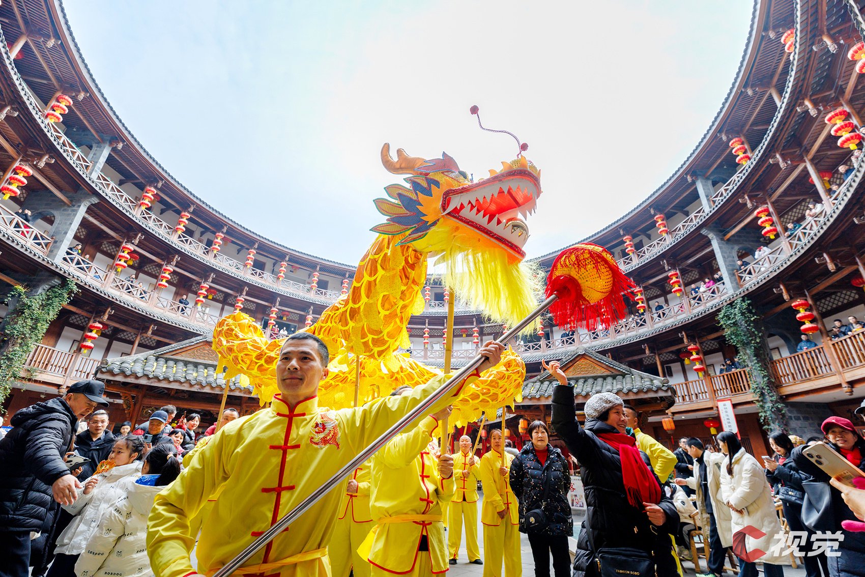 舞龙者身着传统客家服饰,为游客带来新春的祝福