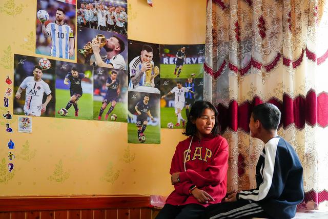Young girl chatting with her brother at home