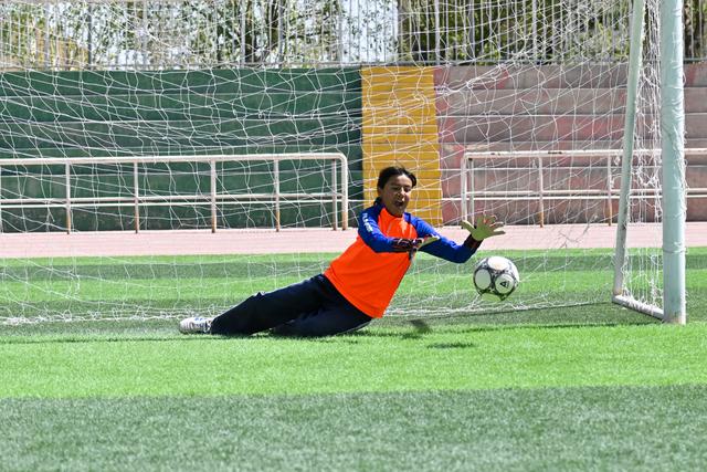 Young girl training on the soccer field