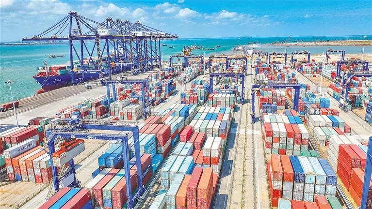 在洋浦国际集装箱码头,集装箱有序堆叠,货轮在港口靠泊。(资料图)