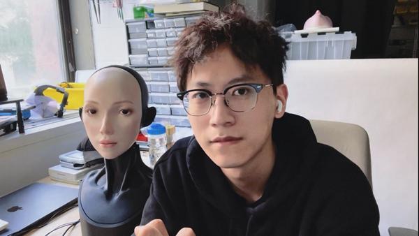 胡宇航与机器人“Emo”。受访者供图
