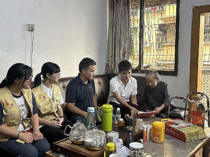 图为艺路生花文化传承实践队队员与社区工作人员探访许妙桃同志