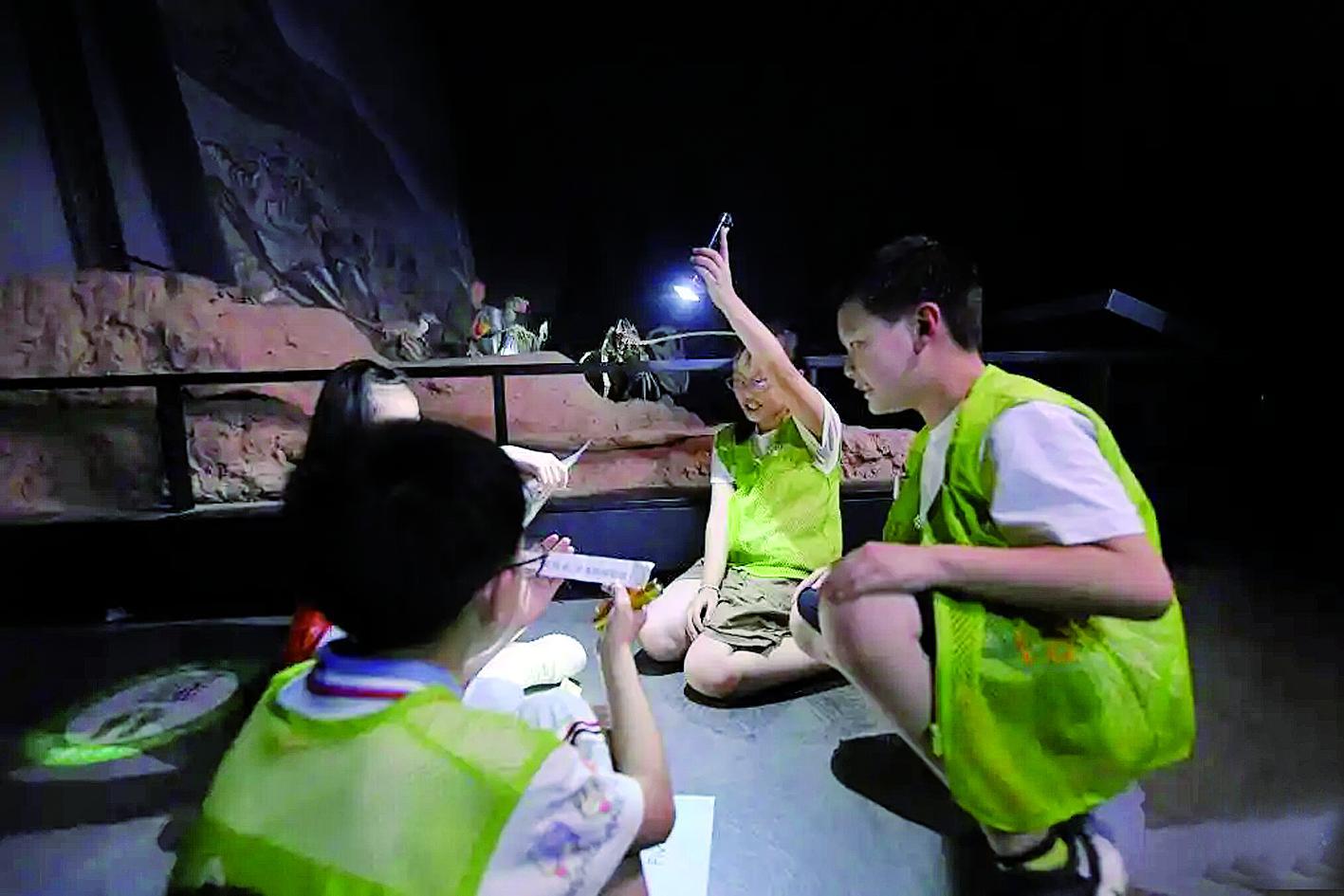 参加夜游的孩子们在博物馆内讨论闯关任务 新华社发