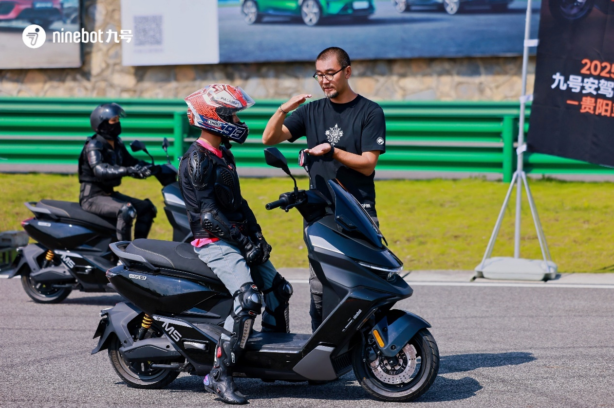 图：九号安驾学院的安驾教官给学员指导安全驾驶规范