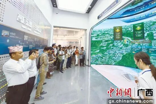 图为讲解员向代表团成员介绍南A中心规划布局。南宁市融媒体中心供图