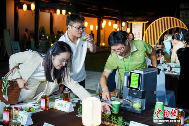 9月21日晚，民众品尝“径山智能抹茶机”制作的抹茶茶饮。(主办方供图)