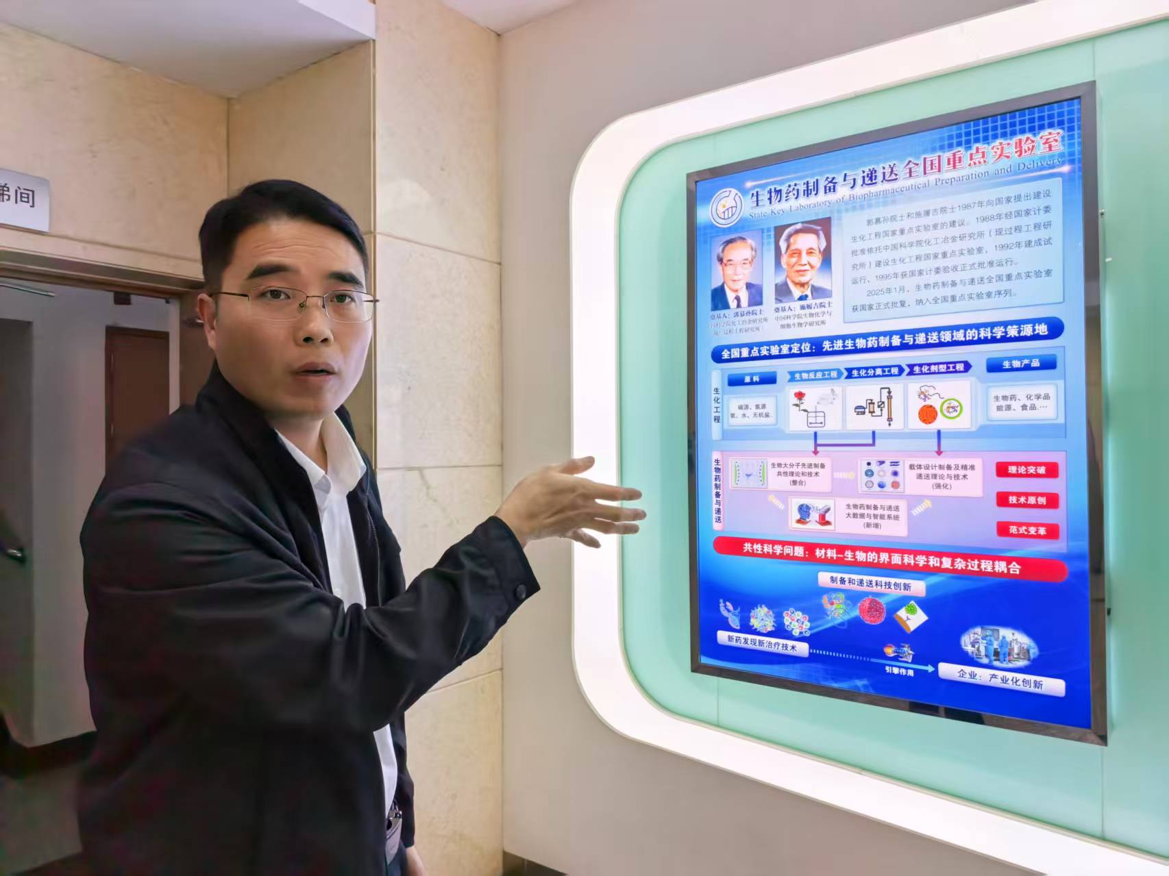     黄永东向记者介绍实验室情况。记者 吴蔚 摄