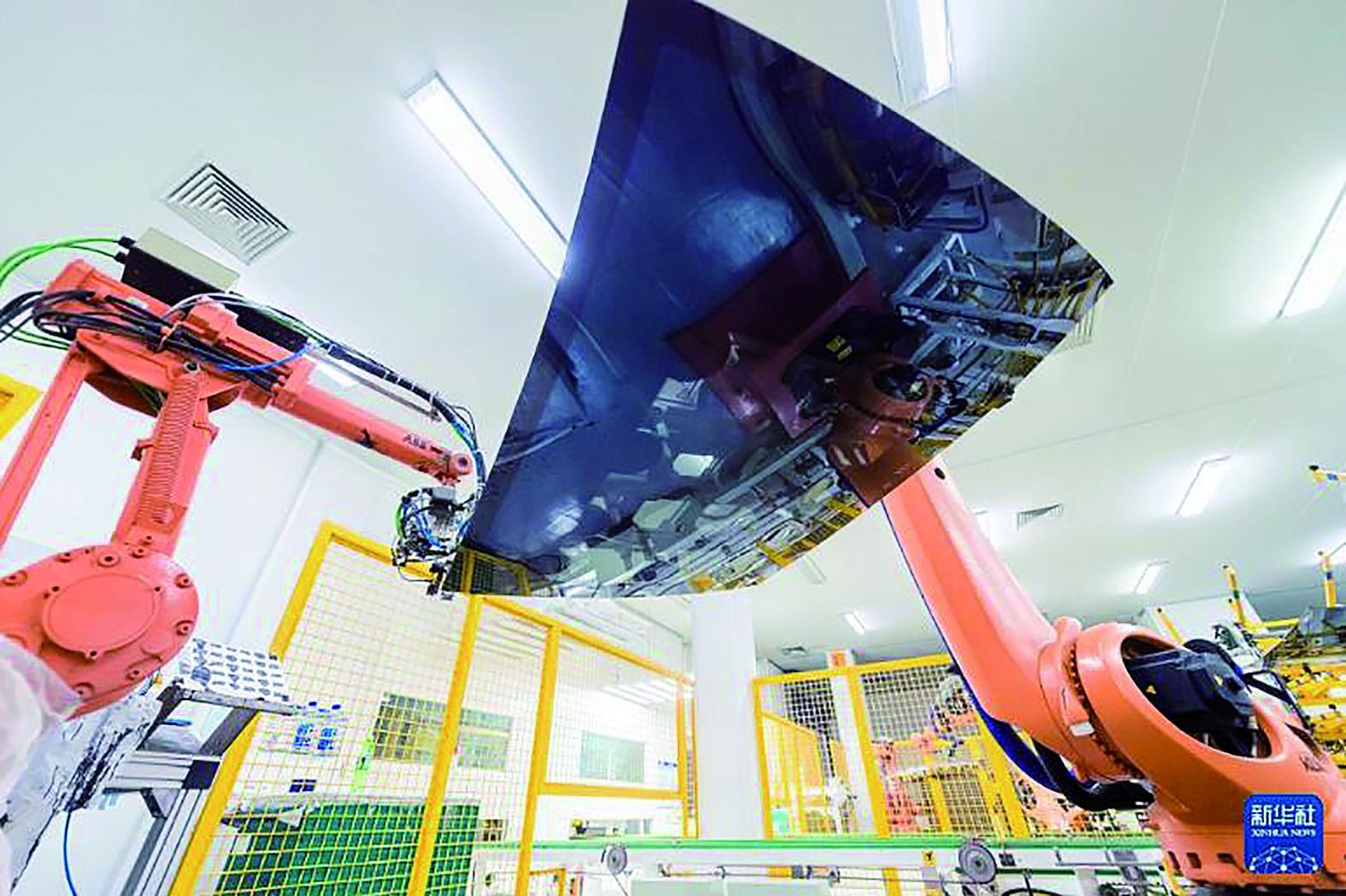 机械臂在福耀汽车玻璃智能工厂的车间生产玻璃产品 新华社发