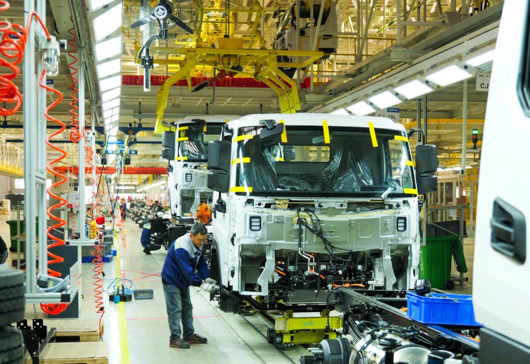 贵州长江汽车有限公司的总装车间内,技术工人在各自岗位上忙碌