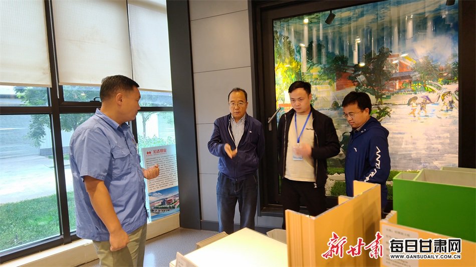 甘肅宏達鋁型材有限公司黨支部書記沈文政（左）向記者介紹產品。新甘肅·每日甘肅網記者 王輝文 攝