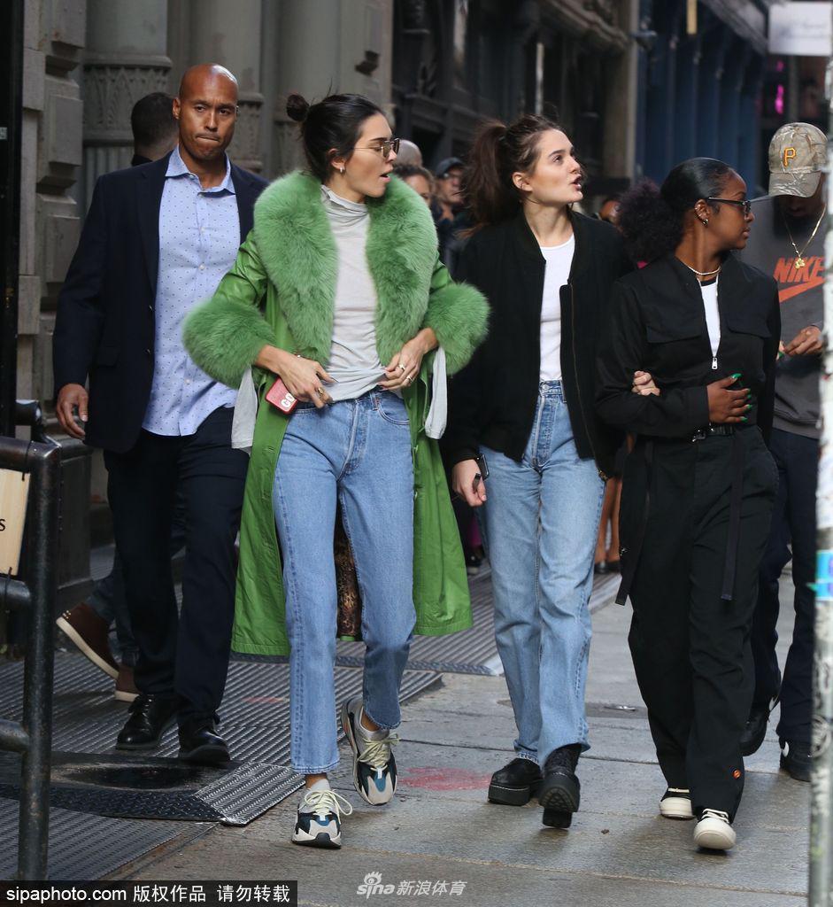 詹娜穿绿色皮草大衣街头骑单车