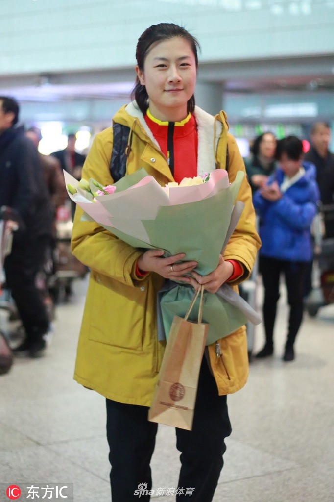 丁宁现身机场手捧鲜花