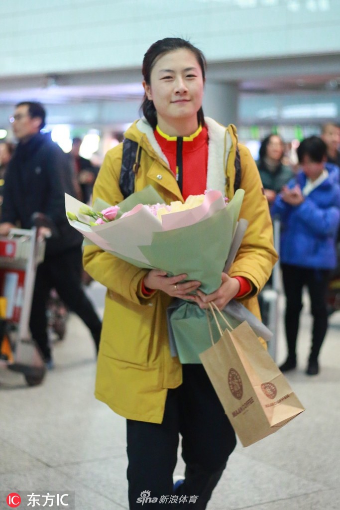 丁宁现身机场手捧鲜花