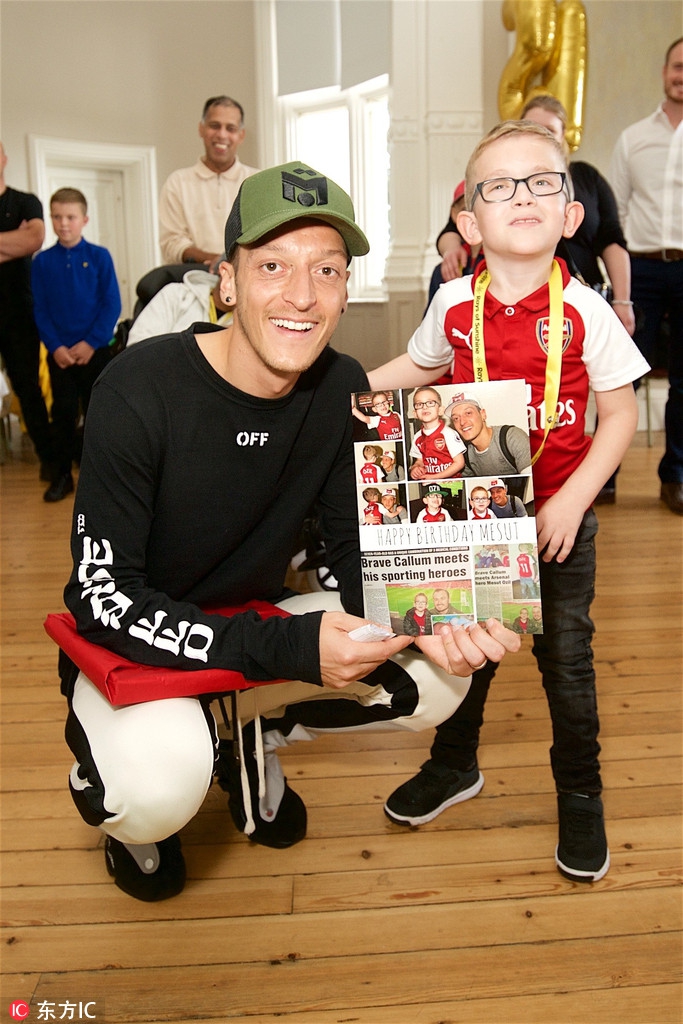 厄齐尔参加公益 与孩子打游戏