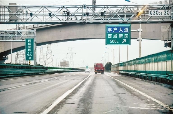 行驶在西安绕城高速上,可以清晰地看到西咸新区出口指示牌。(资料照片)