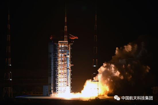  夜幕里，长四丙火箭点火后喷发出耀眼的火焰