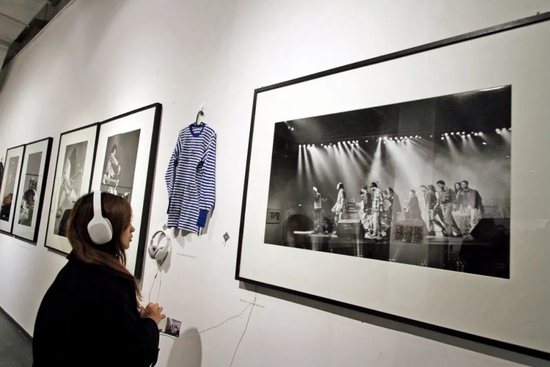 2017年12月18日，“把青春唱完——高原镜头下的中国摇滚时代”摄影展在天津智慧山艺术中心开展。最右一幅照片记录了1994年12月17日，香港红磡演唱会演出结束后，演出者集体致谢后离场。图/中新