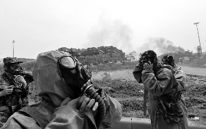 8月14日，中国核生化应急救援队的队员准备进入爆炸区进行空气采样。新华社发 