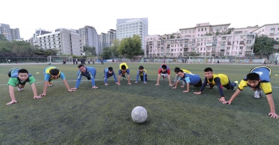 洋教练路易斯（左三）带领小队员们放松身体。