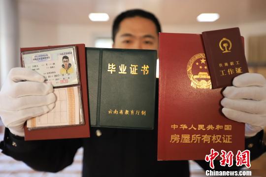 图为民警展示查获的各类假证成品。　周银　摄