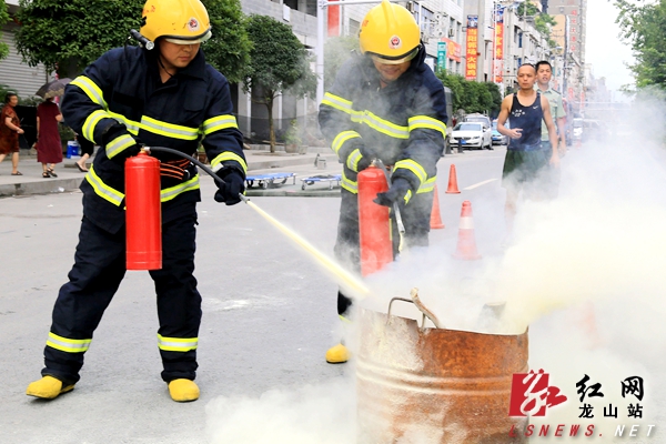 消防战士和社区民兵消防员协同训练灭火器灭火