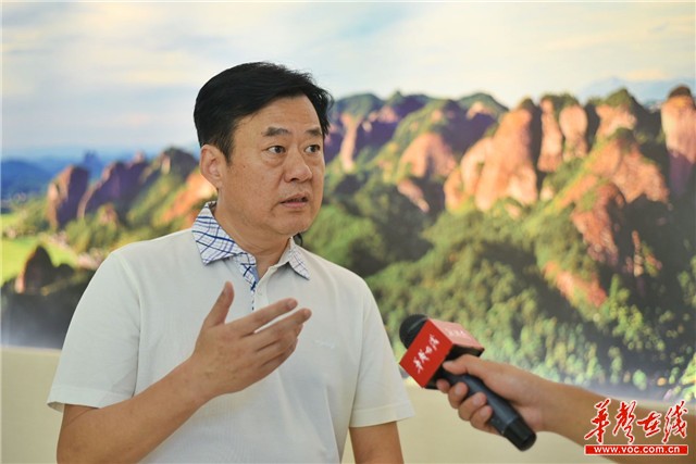 邵阳市人大常委会副主任,新宁县委书记秦立军向记者介绍旅游扶贫"崀山
